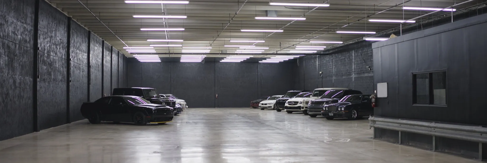 The storage floor at Full Stop Garage, cars parked indoors under even light